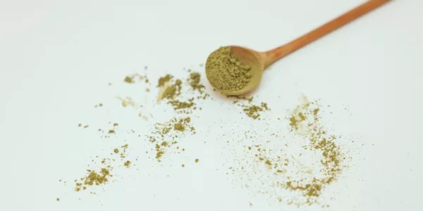 Brown Wooden Spoon with Green Powder