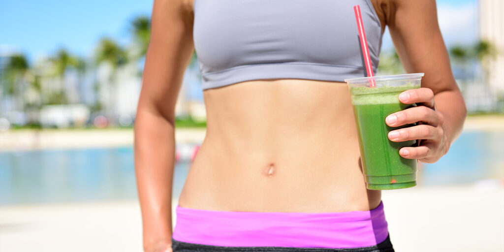 Woman drinking green vegetable smoothie