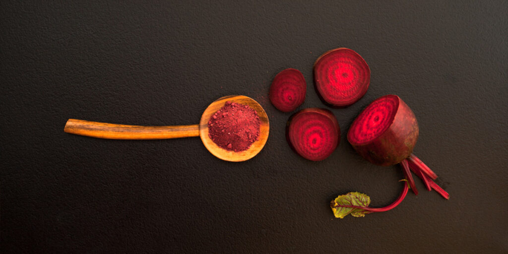 Beetroot Powder in wooden spoon