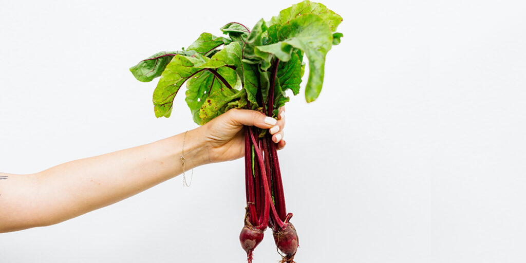 Woman Holding Beetroot Plants