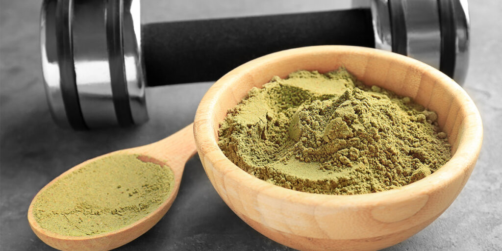 Wooden bowl and spoon of green powder