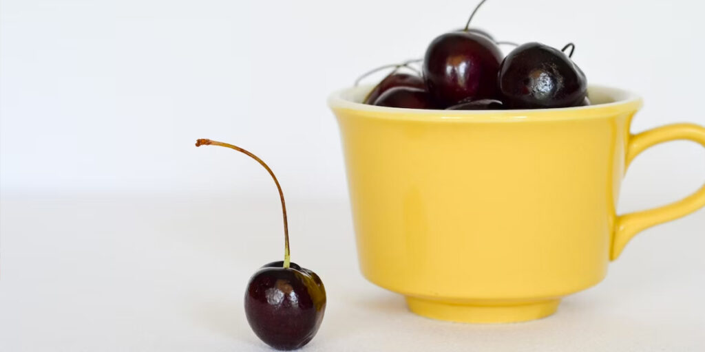 cherry in yellow cup
