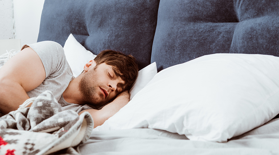 young man sleeping in bed